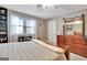 Bright bedroom features built-in shelves, natural light and an elegant dresser with mirror at 100 Smokerise Trce, Peachtree City, GA 30269