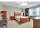 Comfortable bedroom featuring a ceiling fan, a desk and built-in shelving at 100 Smokerise Trce, Peachtree City, GA 30269