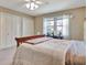 Cozy bedroom with a full bed, neutral decor, double closets, and bright window at 100 Smokerise Trce, Peachtree City, GA 30269