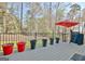 Spacious outdoor deck featuring grill, table with umbrella, and flower pots at 100 Smokerise Trce, Peachtree City, GA 30269
