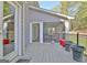 Outdoor deck and access to a screened patio featuring dining table with seating at 100 Smokerise Trce, Peachtree City, GA 30269