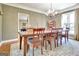 Lovely dining room with a view of the yard, a wooden dining set and chandelier at 100 Smokerise Trce, Peachtree City, GA 30269