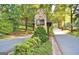 Stone community entrance feature with manicured landscaping and a private street at 100 Smokerise Trce, Peachtree City, GA 30269