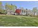 Stately two-story home with manicured lawn and a beautiful, columned front porch at 100 Smokerise Trce, Peachtree City, GA 30269