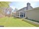 Exterior view of the home with a well-maintained yard, screened porch and neutral color palette at 100 Smokerise Trce, Peachtree City, GA 30269