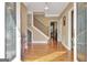 Inviting foyer showcases hardwood floors, a staircase, and a glimpse of the kitchen, offering a warm welcome at 100 Smokerise Trce, Peachtree City, GA 30269