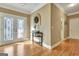 Warm foyer featuring beautiful hardwood floors, a decorated console table, and views to other living spaces at 100 Smokerise Trce, Peachtree City, GA 30269