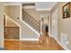 Elegant foyer featuring hardwood floors, a staircase, and a view to the kitchen at 100 Smokerise Trce, Peachtree City, GA 30269