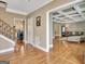 Spacious foyer showcases hardwood floors, an elegant staircase, and an open layout to living room and kitchen at 100 Smokerise Trce, Peachtree City, GA 30269
