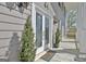 A charming home entrance features a decorative glass front door, enhanced by stylish outdoor lighting at 100 Smokerise Trce, Peachtree City, GA 30269