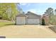 Three car garage with carriage doors offer ample parking and storage space with attractive, neutral exterior at 100 Smokerise Trce, Peachtree City, GA 30269