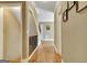 Hallway with hardwood floors, white trim, leading to a staircase and open living space at 100 Smokerise Trce, Peachtree City, GA 30269
