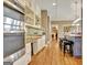 Kitchen with stainless steel oven, white cabinets, and open shelving at 100 Smokerise Trce, Peachtree City, GA 30269