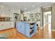 Beautiful kitchen with a large blue island, stainless steel appliances, and ample counter space at 100 Smokerise Trce, Peachtree City, GA 30269