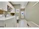 Bright laundry room with tile flooring, washer, dryer and storage bench at 100 Smokerise Trce, Peachtree City, GA 30269