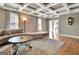 Bright living room featuring coffered ceiling, hardwood floors, and large windows at 100 Smokerise Trce, Peachtree City, GA 30269