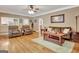 Open living room with hardwood floors and a view of the kitchen at 100 Smokerise Trce, Peachtree City, GA 30269