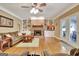 Bright living room with a cozy fireplace and access to outdoor patio at 100 Smokerise Trce, Peachtree City, GA 30269