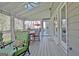 Covered patio with vaulted ceiling features dining table with seating, lounge chair, and patio door at 100 Smokerise Trce, Peachtree City, GA 30269