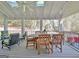 Covered patio with vaulted ceiling features ceiling fan, skylight and dining table with outdoor seating at 100 Smokerise Trce, Peachtree City, GA 30269