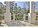 Scenic view from the porch, showcasing a lush yard with mature trees at 100 Smokerise Trce, Peachtree City, GA 30269