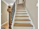 Interior staircase with wooden handrail and white risers with wooden treads at 100 Smokerise Trce, Peachtree City, GA 30269