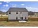 Rear exterior showcasing the spacious backyard, patio, and fencing, providing ample room for outdoor activities and privacy at 517 Daffodil Ln, Mcdonough, GA 30253
