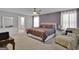 Elegant bedroom with a queen-sized bed, side tables, dresser, armchair, and a purple accent wall provides a luxurious retreat at 517 Daffodil Ln, Mcdonough, GA 30253