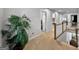 Upper hallway with tan carpet, white walls and a plant near the stairway railing at 517 Daffodil Ln, Mcdonough, GA 30253