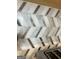 Close-up of stylish kitchen backsplash with a unique arrow pattern and metallic accents at 517 Daffodil Ln, Mcdonough, GA 30253