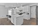 Well-lit kitchen boasts a central island, white cabinets, and stainless steel appliances at 517 Daffodil Ln, Mcdonough, GA 30253