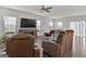 Cozy living room featuring hardwood floors, a large television, and comfortable leather seating at 517 Daffodil Ln, Mcdonough, GA 30253