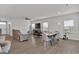 Spacious living room with a ceiling fan, a large television, and wood-look floors at 517 Daffodil Ln, Mcdonough, GA 30253