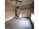 Bedroom view showcases stained carpet, a ceiling fan, and open closet space at 2884 Haddon Dr, Rex, GA 30273