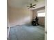 Bedroom features stained carpet and a ceiling fan with a power wheelchair near the window at 2884 Haddon Dr, Rex, GA 30273