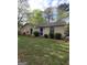 Charming one-story home with brick exterior, arched windows and a green lawn at 2884 Haddon Dr, Rex, GA 30273