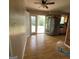 Bright kitchen area with access to the outdoors, featuring wood-look flooring and stainless steel refrigerator at 2884 Haddon Dr, Rex, GA 30273