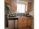 Kitchen featuring stainless steel dishwasher, tile backsplash, and wood cabinetry at 2884 Haddon Dr, Rex, GA 30273