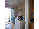 Laundry room featuring a washer, shelf, and exterior access door to the back yard at 2884 Haddon Dr, Rex, GA 30273