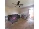 Inviting living room featuring neutral carpet, a ceiling fan, and large arched window at 2884 Haddon Dr, Rex, GA 30273