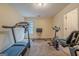 Basement gym area equipped with treadmill, stationary bike, and weights at 7415 Northampton Ct, Cumming, GA 30040
