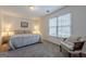 Bedroom with a large window, a plush bed, and an upholstered chair at 7415 Northampton Ct, Cumming, GA 30040