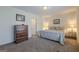 Bedroom featuring a plush bed, vintage dresser, and neutral decor at 7415 Northampton Ct, Cumming, GA 30040