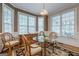 Cozy breakfast nook features a glass table, wicker chairs, and ample natural light at 7415 Northampton Ct, Cumming, GA 30040