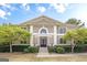 Stately two-story home featuring a symmetrical facade, manicured landscaping, and elegant double door entry at 7415 Northampton Ct, Cumming, GA 30040
