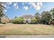 Stately home with lush front lawn and beautiful landscaping, reflecting curb appeal and elegance at 7415 Northampton Ct, Cumming, GA 30040