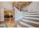 Stunning foyer with hardwood floors, elegant staircase, and chandelier, creating a grand entrance at 7415 Northampton Ct, Cumming, GA 30040