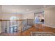 Second-floor foyer with hardwood floors, decorative railing, and views into a bedroom at 7415 Northampton Ct, Cumming, GA 30040