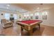 Spacious game room featuring a classic pool table, plush seating, and movie-themed decor for entertainment at 7415 Northampton Ct, Cumming, GA 30040
