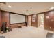 Home theater with a large screen, surround sound, and dark walls for an immersive viewing experience at 7415 Northampton Ct, Cumming, GA 30040